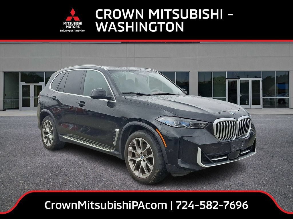 2024 BMW X5 xDrive40i in Black Sapphire Metallic — front three-quarter view