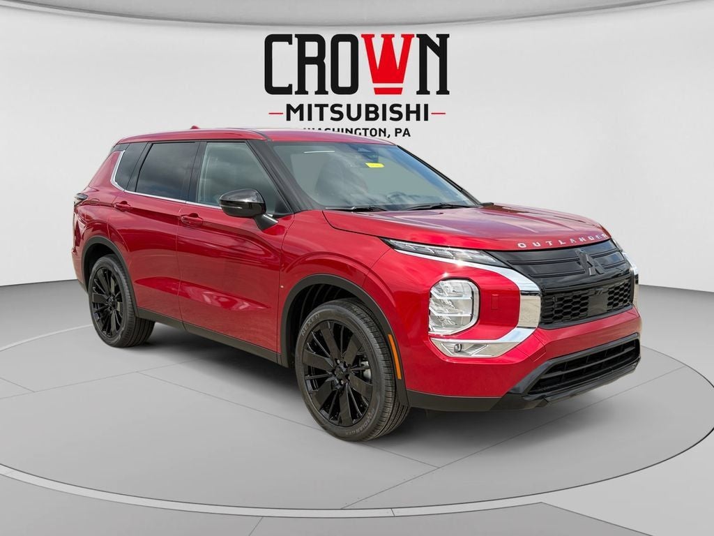 2026 Mitsubishi Outlander LE in Red Diamond — front three-quarter view